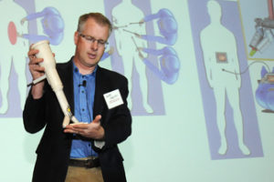 Shane Farritor, an engineer at UNL and co-founder of Virtual Incision, displays his new surgical device during UNeMed Corporation's inaugural UNMC Startup Company Demonstration Day.