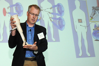 Shane Farritor, an engineer at UNL and co-founder of Virtual Incision, displays his new surgical device during UNeMed Corporation's inaugural UNMC Startup Company Demonstration Day Monday afternoon in Omaha.