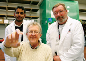 ProTransit Nanotherapy president and CEO Gary Madsen, Ph.D., (center) shows off a vial of prototypes that could one day be incorporated into skin care products such as sunscreen and cosmetics. The nanoparticles, formulated by scientists Steve Curran and Bala Vamsi Karuturi, Ph.D.,(left) and Steve Curran (right), are vehicles that can deliver powerful antioxidants to the deepest layers of skin where they can help prevent skin cancer, wrinkles and blemishes.
