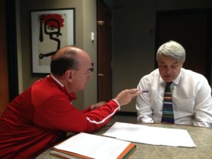 Greg Sharpe (left) and interim president of the University of Nebraska chat about the value of the University to the state during a pre-rocrded interview that aired during the Nebraska-Iowa football game last week.