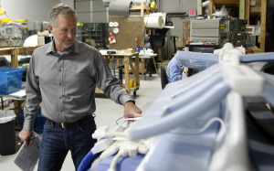 ScanMed founder and CEO Randy Jones, Ph.D., looks over one his prototypes for an MRI scanning coil that will help physicians finally get detailed images of a patient’s lung tissue. (Photo: Charlie Litton)