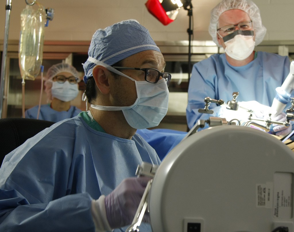 UNMC surgeon Dmitry Oleynikov (left) and UNL engineer Shane Farritor test a surgical robot prototype during a recent trial in Omaha. Their collaboration created a startup company, Virtual Incision, which hopes to make major surgery—like a bowel resection—a laparoscopic procedure.