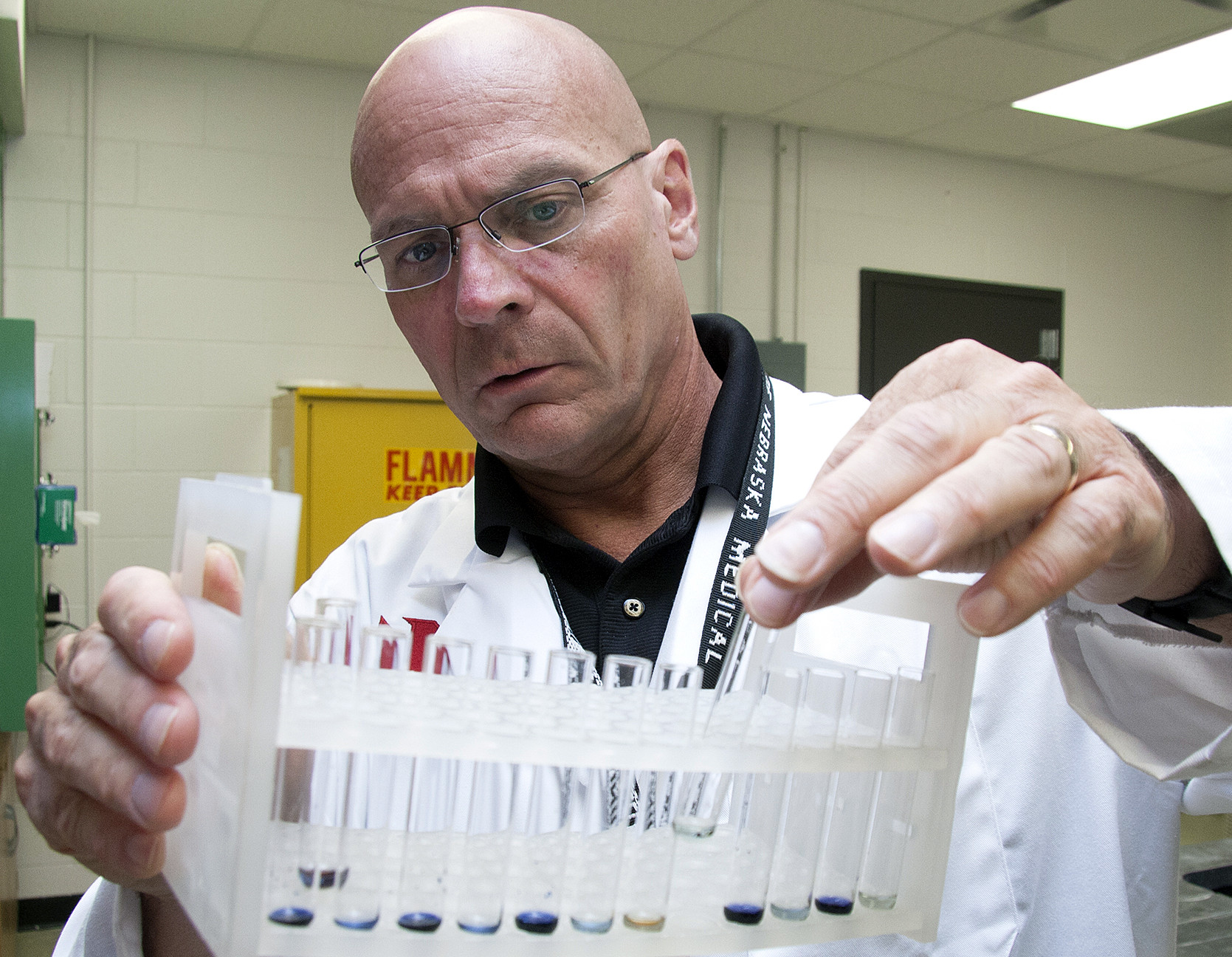 UNMC researcher Sam Sanderson, Ph.D., checks the results of a recent quality control test at his Omaha lab. His startup company, Prommune, has scheduled a test for a new H1N1 vaccine on pigs in Aug. 2015.