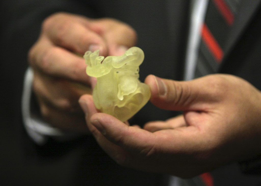 UNeMed's annual Innovation Week continued Oct. 4 with a panel discussion about the biomedical applications in healthcare. Above, R. Gabe Linke, the 3D printing coordinator at Children's Hospital and Medical Center in Omaha, shows guests a 3D-printed model of a newborn's heart. Surgeons used the model to study abnormalities, and planned an eventually successful procedure to correct the problems.