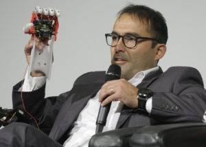 UNO researcher Jorge Zuniga, Ph.D.—seen here during an Innovation Week event last October—holds up a cybernetic prosthetic hand, which he created almost entirely with 3D printers.