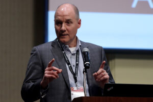 Kenneth Bayles, PhD, UNMC's Vice Chancellor for Research, addresses an estimated 165 attendees during the 2023 Innovation Awards Ceremony on Nov. 2, 2023. 