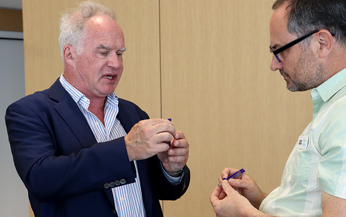 Precision Syringe CEO Adrian Blake demonstrates his company's patented syringe design to a guest during the May 28, 2026, Idea Pub:Morning Edition. The syringe was invented at UNMC. Precision Syringe CEO Adrian Blake demonstrates his company's patented syringe design to a guest during the May 28, 2026, Idea Pub:Morning Edition. The syringe was invented at UNMC.