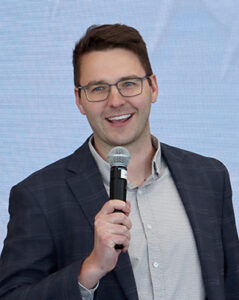 Riley Reynolds, CEO and founder of Rheam Medical, explain how his company plans to improve minimally invasive procedures during his presentation at the networking event, Idea Pub: Morning Edition, held in the Forge Event Hall at Catalyst Omaha in the Edge District on April 30, 2026.