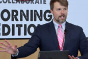 UNeMed Business Development Manager and Morning Edition organizer Tyler Scherr, PhD, addresses the gathering during brief welcoming remarks at the April 30, 2026, installment of Idea Pub: Morning Edition in the Forge Event Hall at Catalyst Omaha in the Edge District.